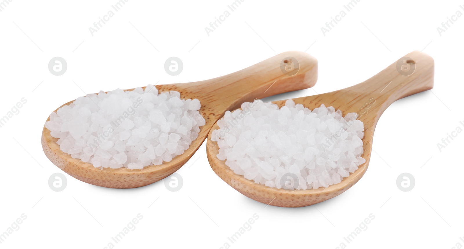 Photo of Wooden spoons with natural sea salt isolated on white