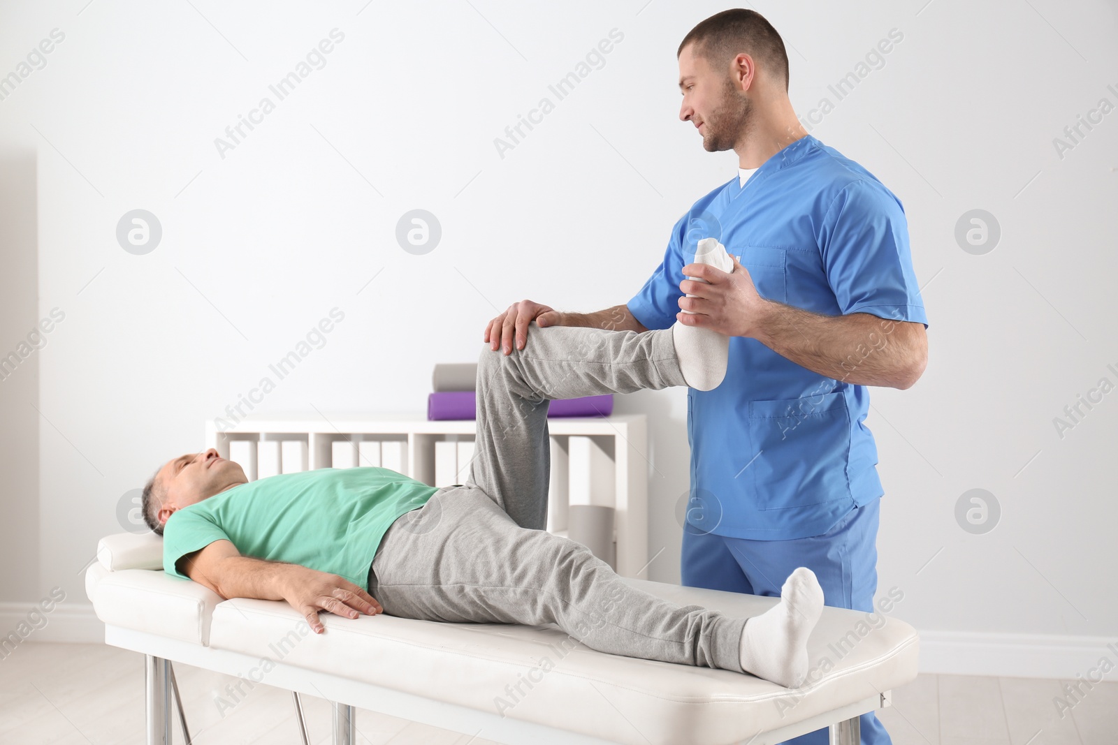 Photo of Doctor working with patient in hospital. Rehabilitation physiotherapy