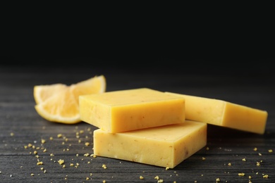 Handmade soap bars and citrus fruit on table