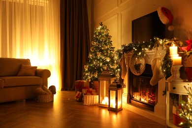 Photo of Beautiful room interior with fireplace and Christmas decor in evening