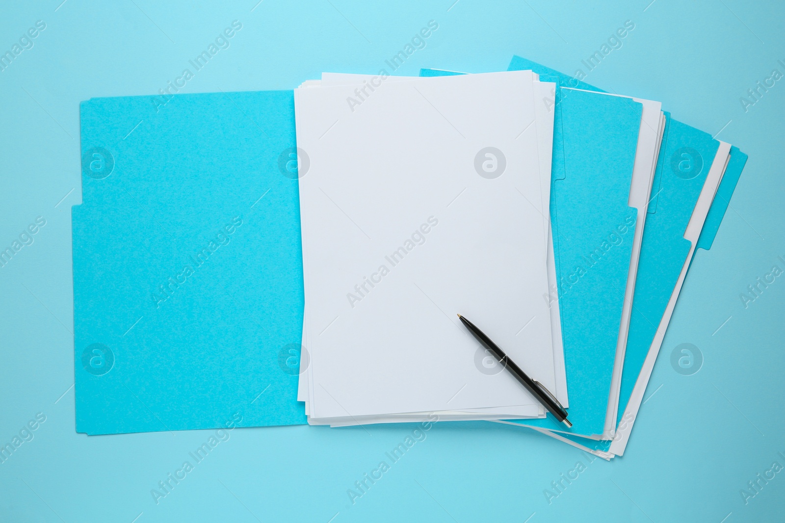 Photo of Turquoise files with blank sheets of paper and pen on light blue background, top view. Space for design