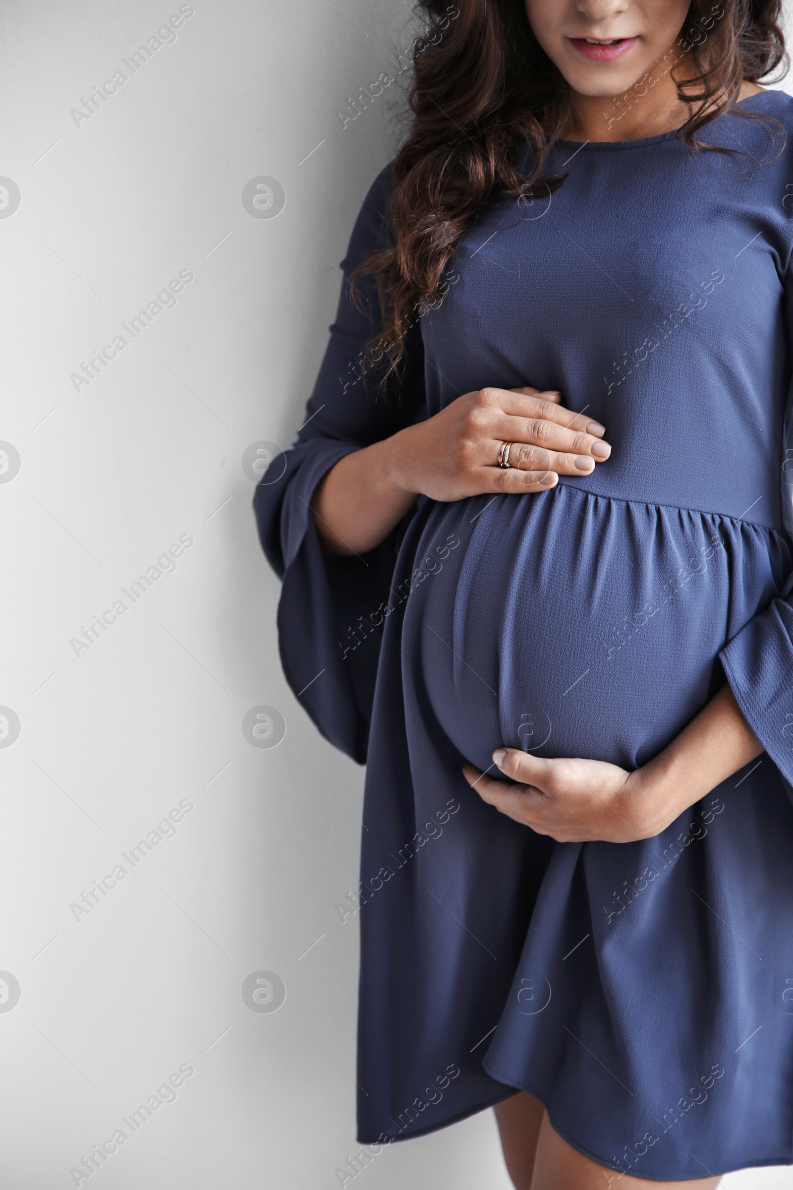 Photo of Happy young pregnant woman on white background