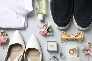 Photo of Wedding stuff. Flat lay composition with stylish boutonniere on light gray background