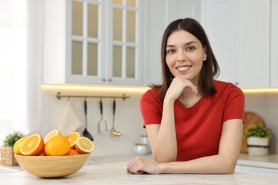 Portrait of beautiful young woman in kitchen