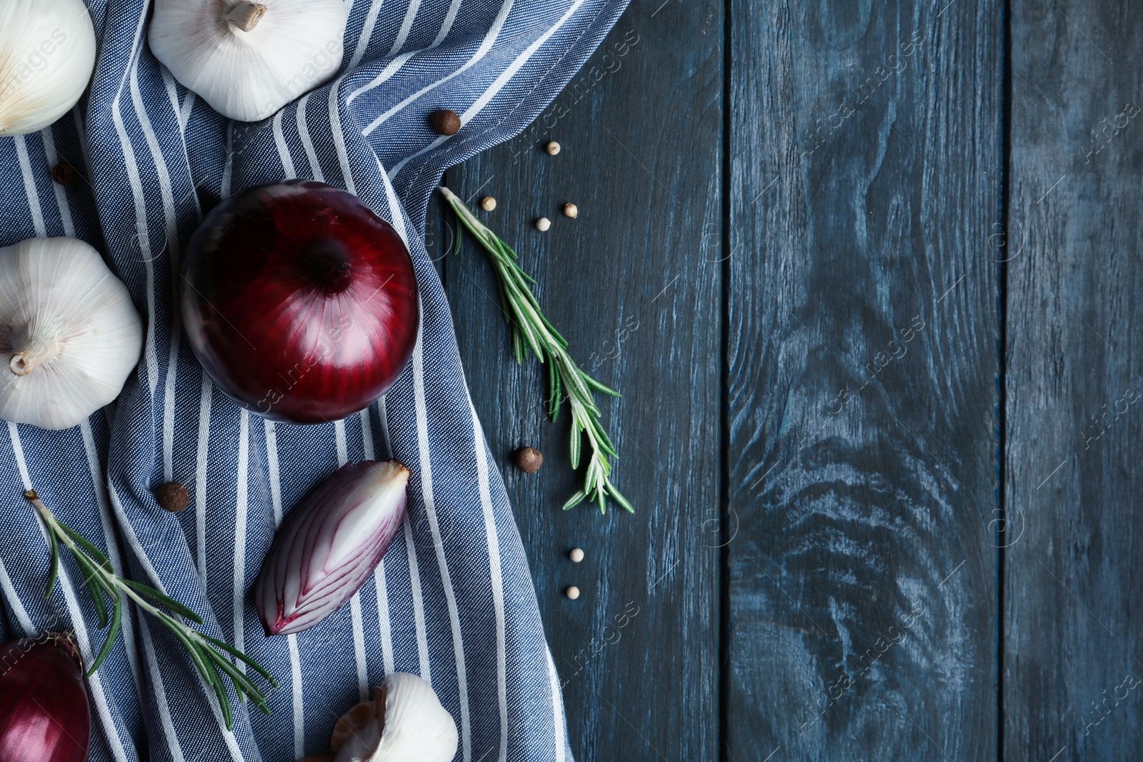 Photo of Flat lay composition with garlic, onions and space for text on wooden background