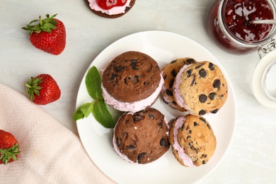 Photo of Sweet delicious ice cream cookie sandwiches served on table, flat lay