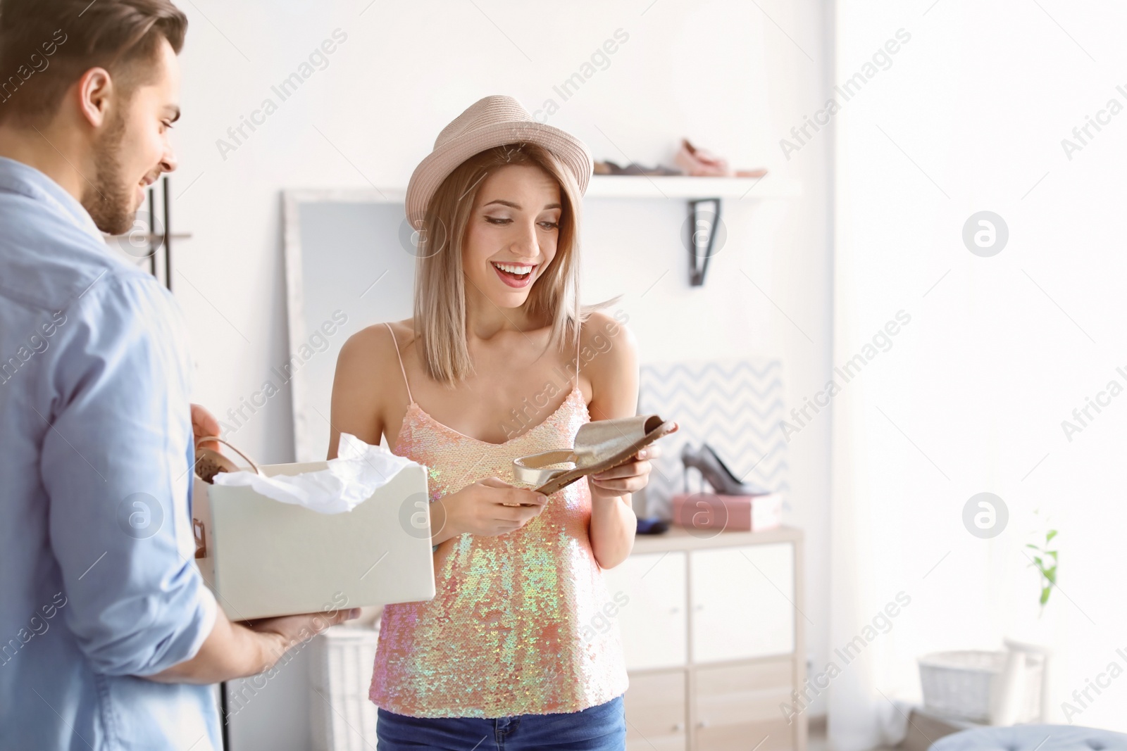 Photo of Young couple choosing shoes in store