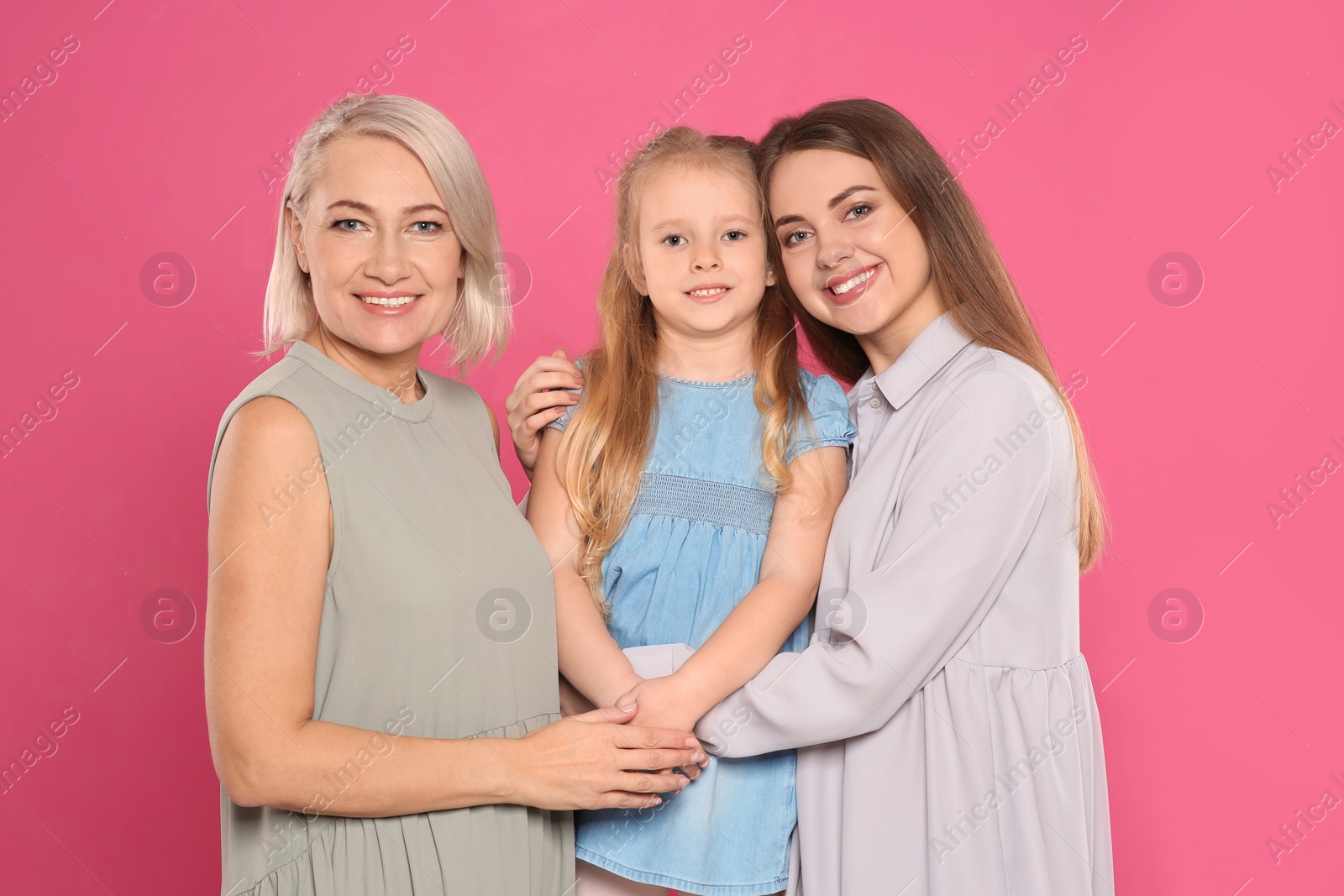 Photo of Portrait of young woman, her daughter and mature mother on color background