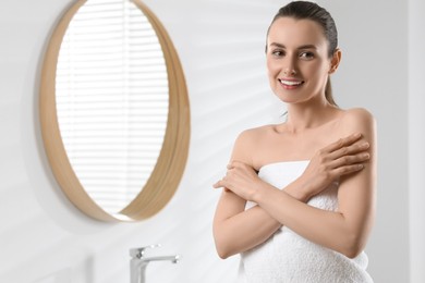 Photo of Happy woman with smooth skin in bathroom, space for text