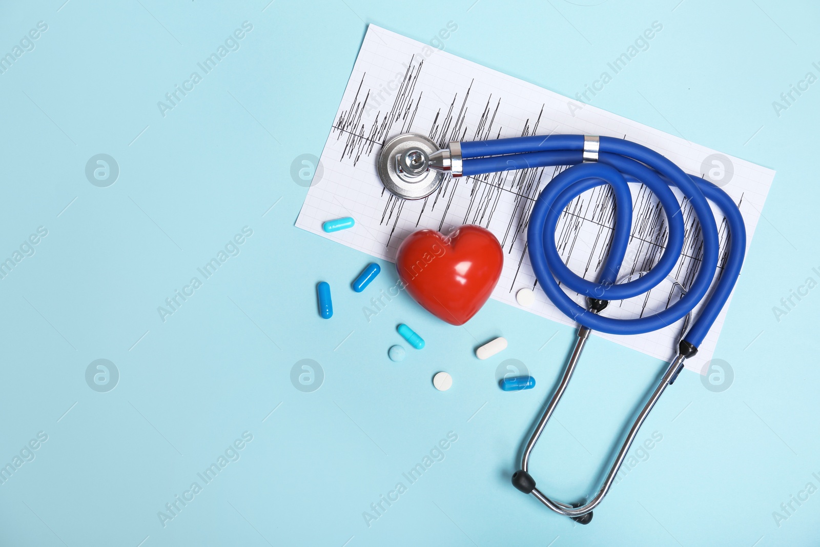 Photo of Stethoscope, cardiogram and pills on color background. Cardiology service
