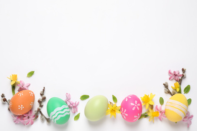 Flat lay composition with Easter eggs on white background. Space for text