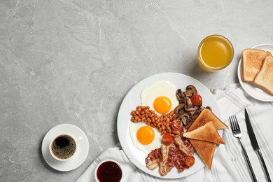 Photo of Traditional English breakfast served on grey marble table, flat lay. Space for text