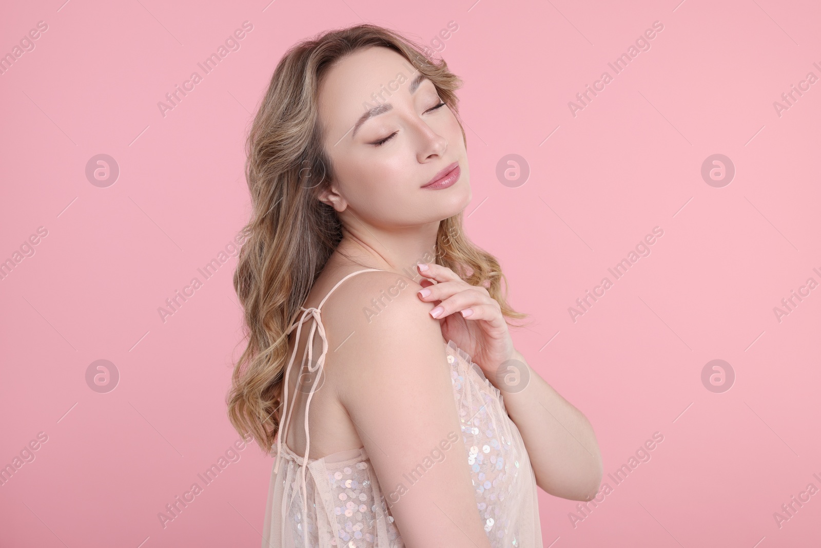 Photo of Portrait of beautiful woman on pink background