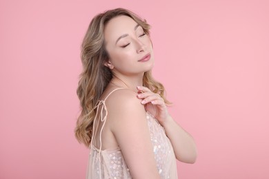 Portrait of beautiful woman on pink background