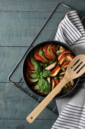 Photo of Delicious ratatouille on light blue wooden table, top view