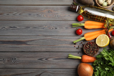 Flat lay composition with ingredients for cooking on wooden table. Space for text