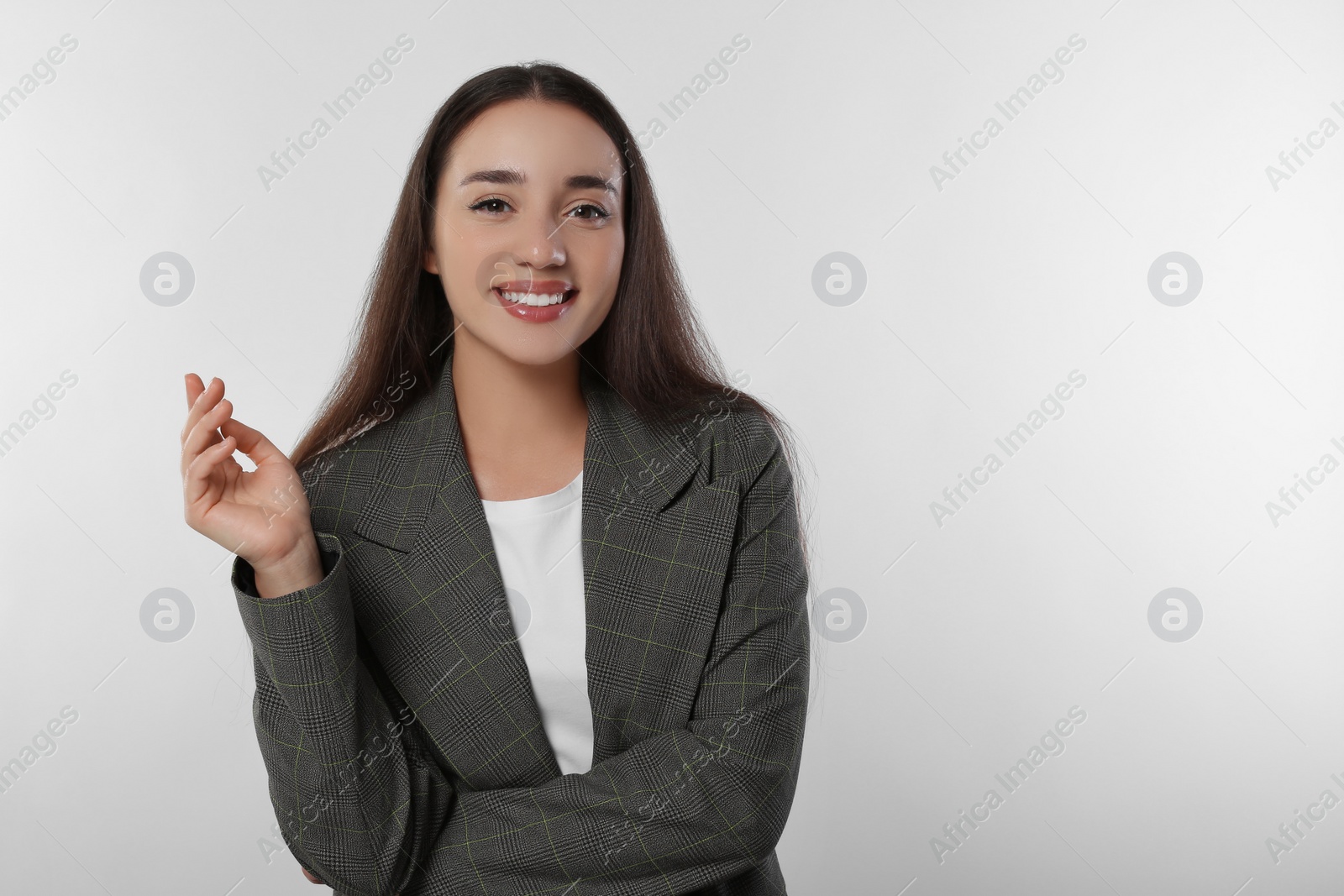 Photo of Portrait of happy young woman in stylish jacket on white background. Space for text