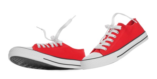 Photo of Pair of red classic old school sneakers on white background