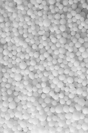 Photo of Pellets of ammonium nitrate as background, top view. Mineral fertilizer
