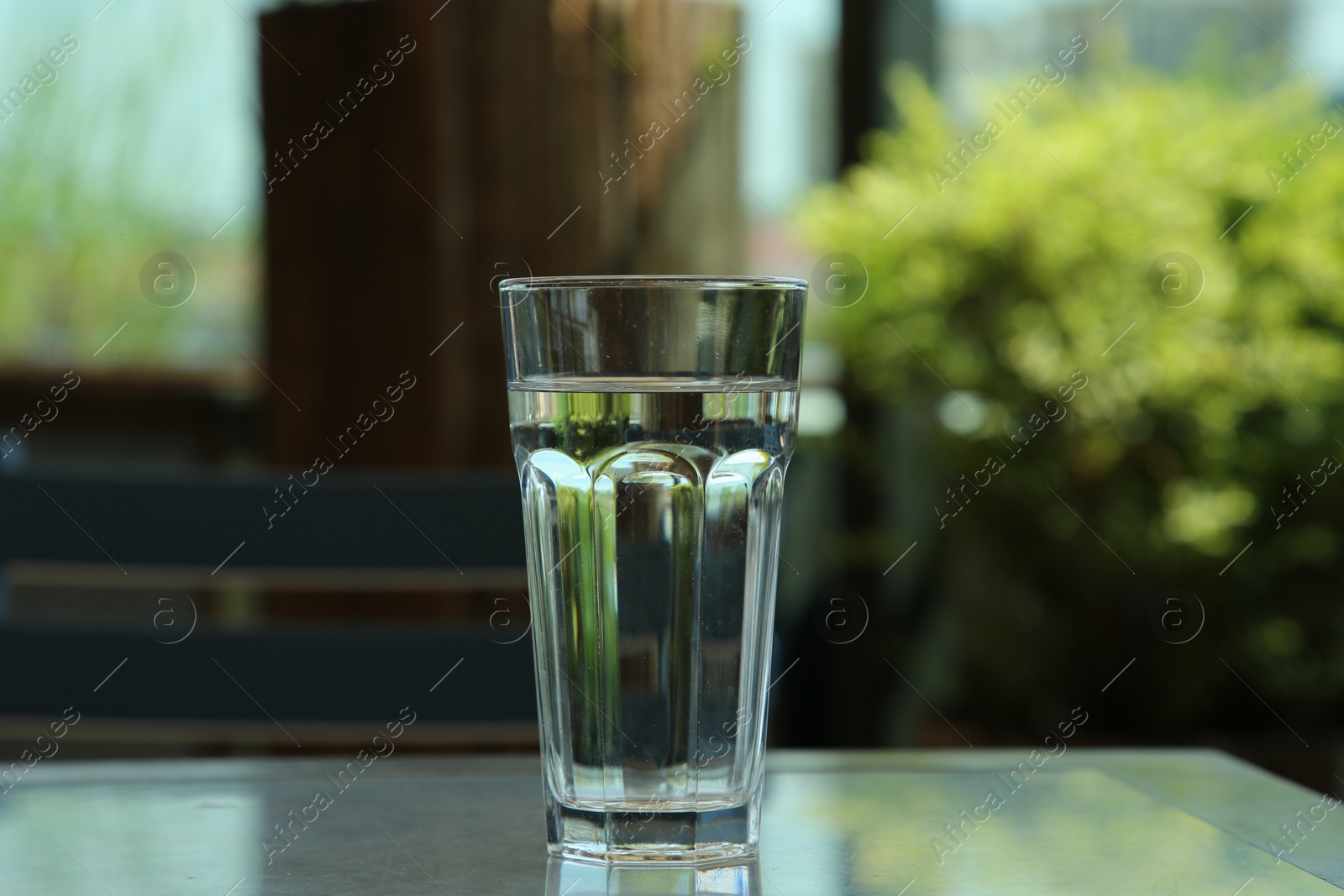 Photo of Glass of fresh water on table indoors