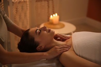 Photo of Young woman receiving body massage in spa salon