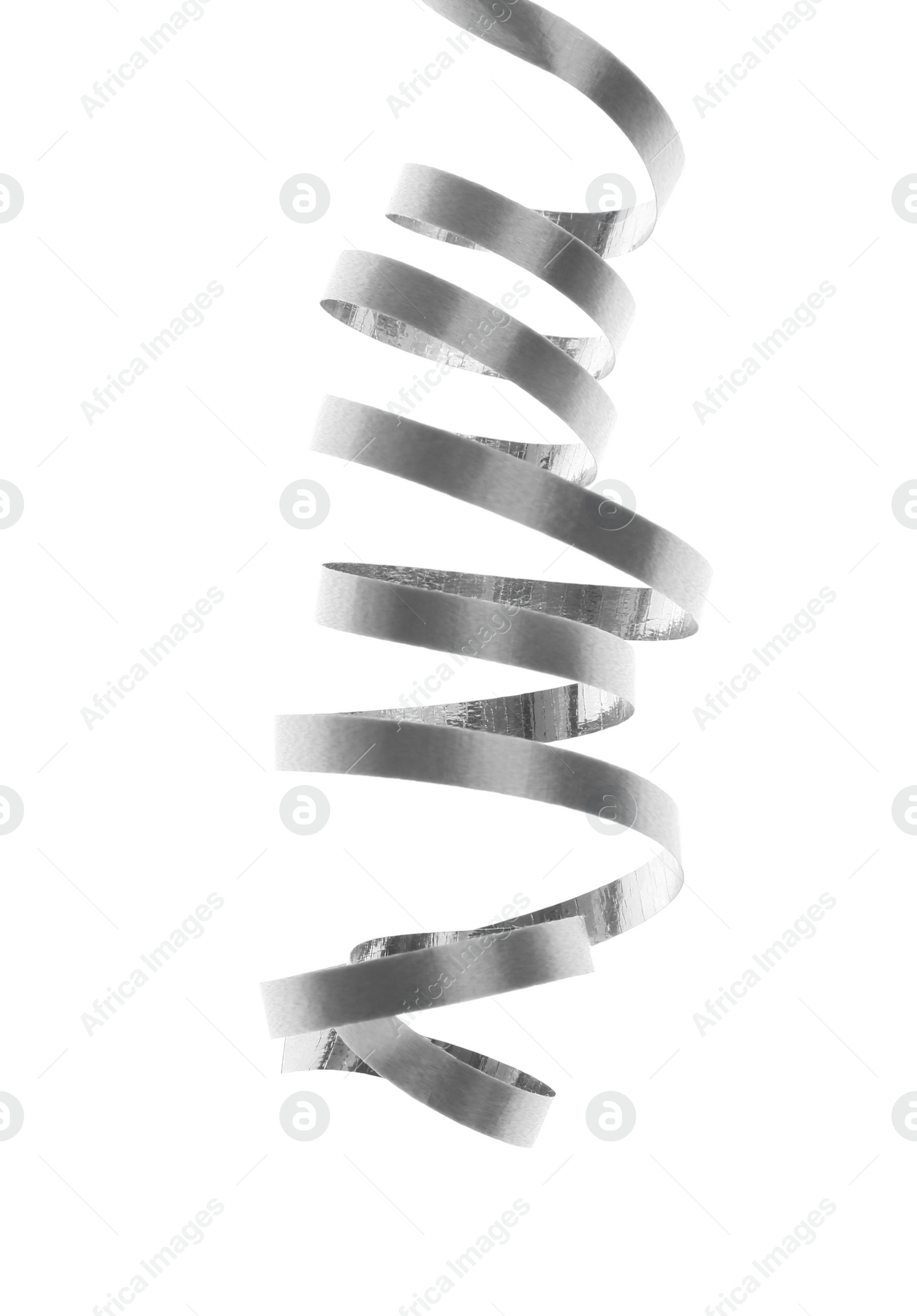 Photo of Shiny serpentine streamer on white background. Festive decor