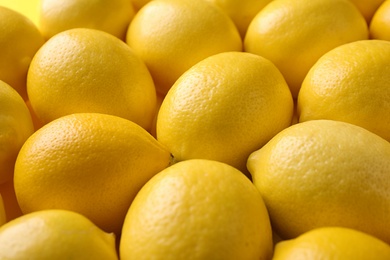 Fresh ripe lemon fruits as background, closeup