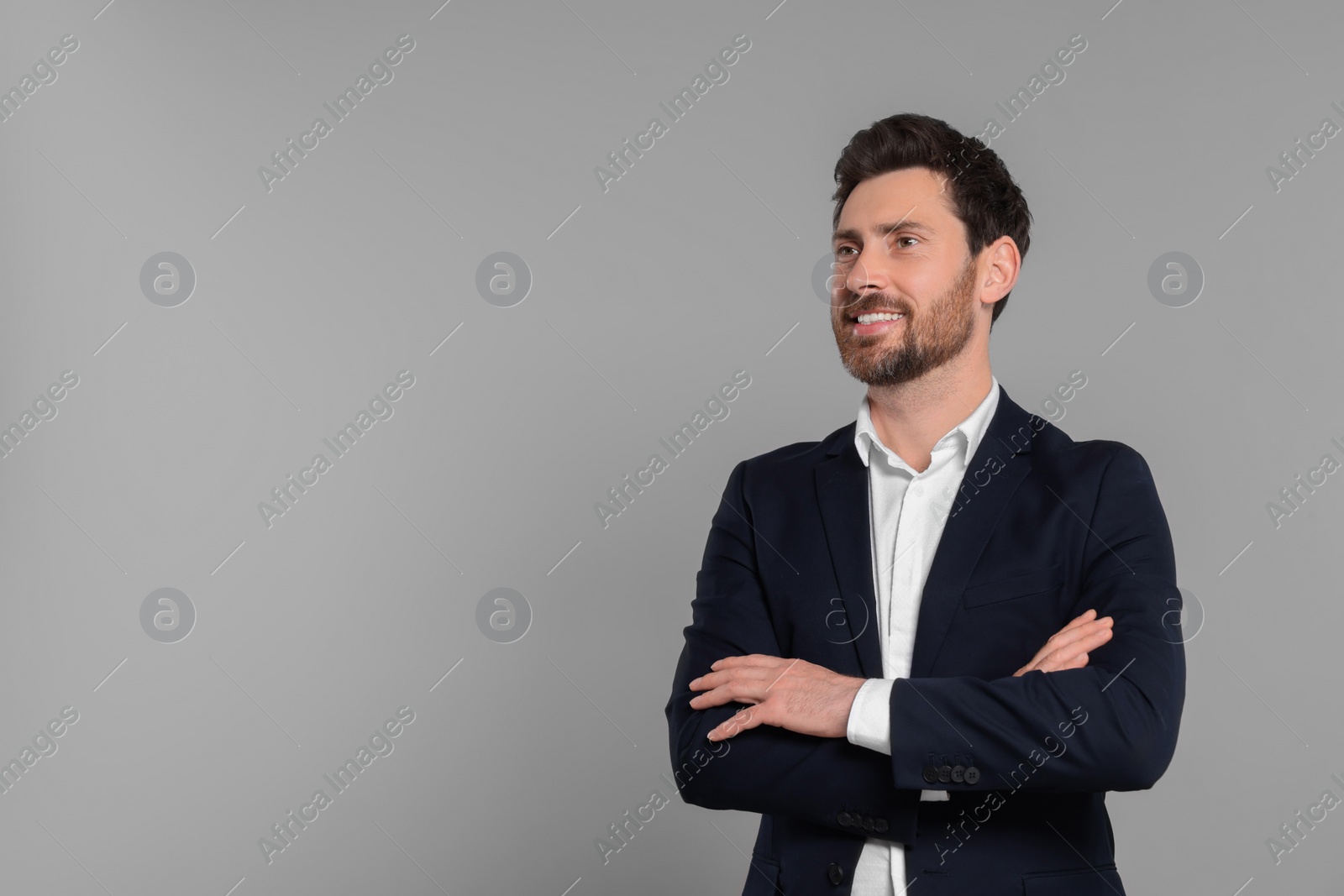 Photo of Happy real estate agent on grey background. Space for text