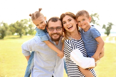 Happy family spending time together with their children outdoors