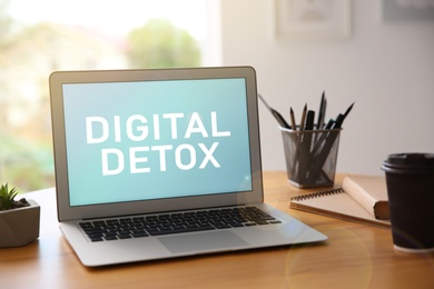Laptop with text Digital Detox on screen at workplace