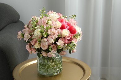 Beautiful bouquet of fresh flowers on coffee table in room, space for text