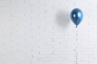 Bright balloon near brick wall, space for text. Party time