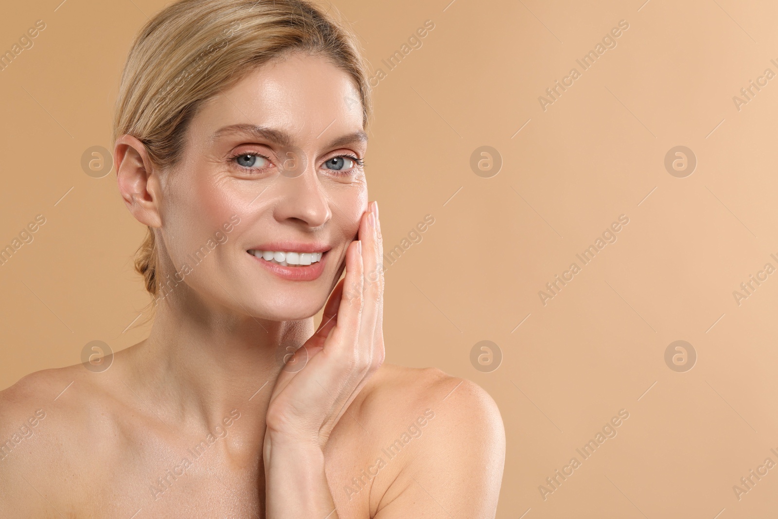 Photo of Beautiful woman with healthy skin on beige background, space for text