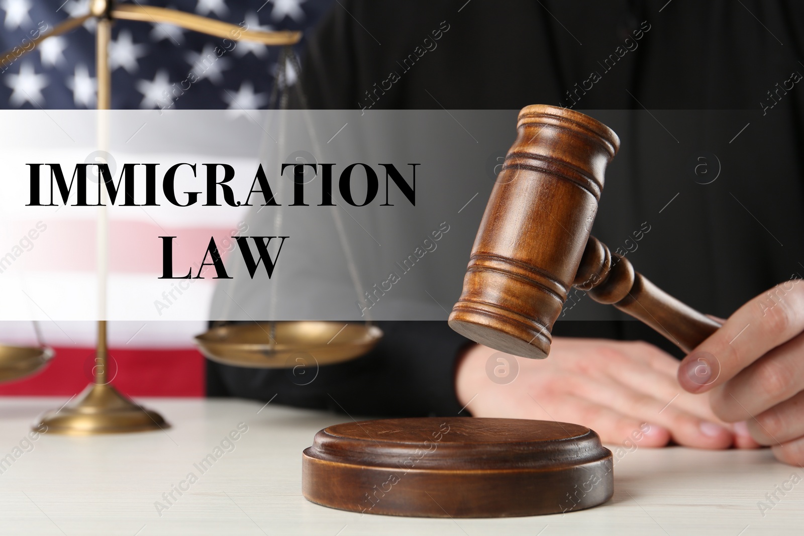 Image of Immigration law. Judge with gavel at white wooden table near flag of United States, closeup