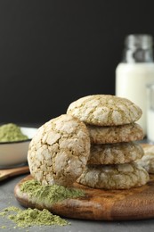 Photo of Tasty matcha cookies and powder on grey table