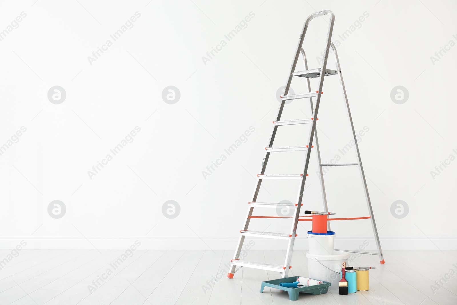 Photo of Step ladder and decorator's tools in light room