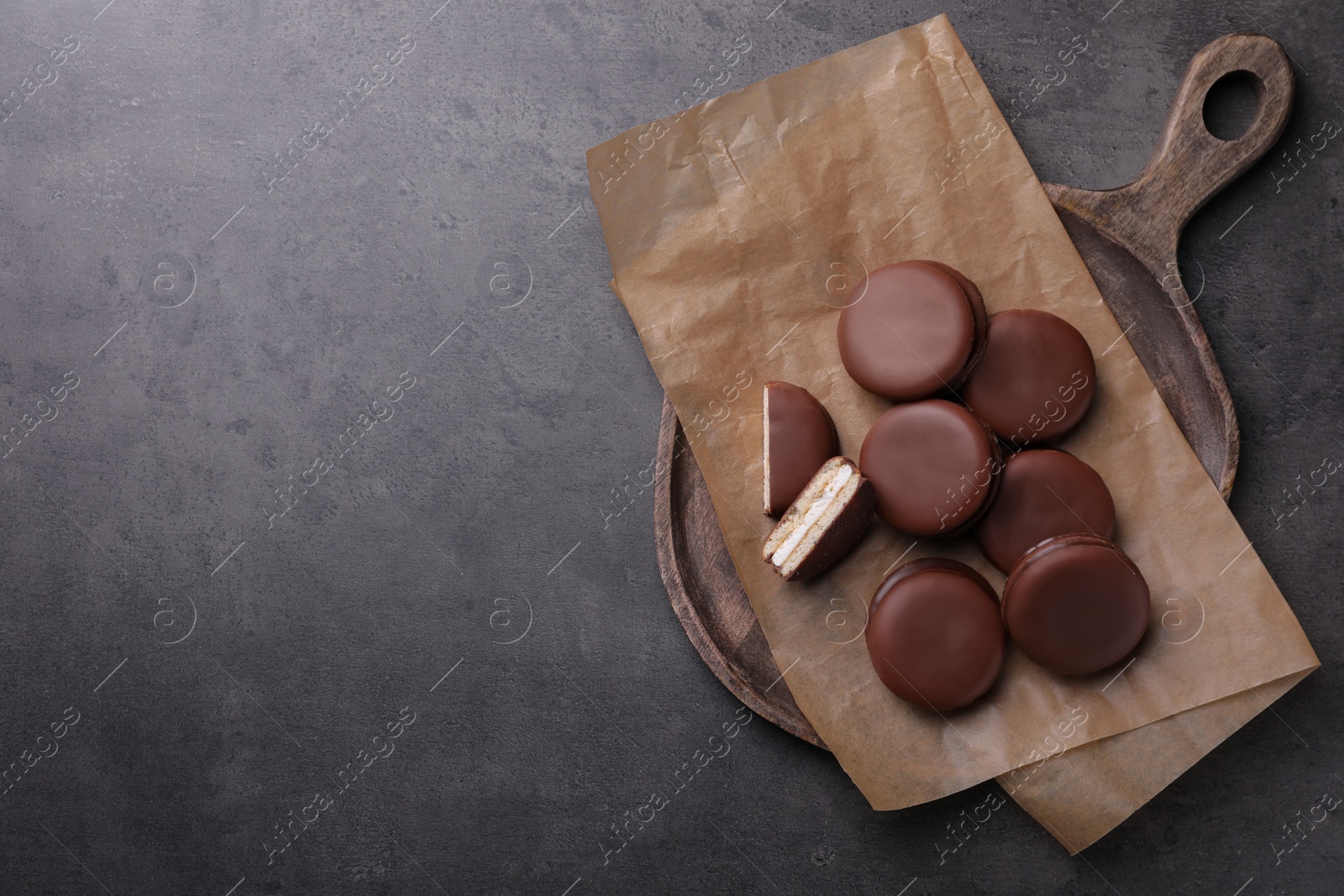 Photo of Tasty choco pies on grey table, top view. Space for text