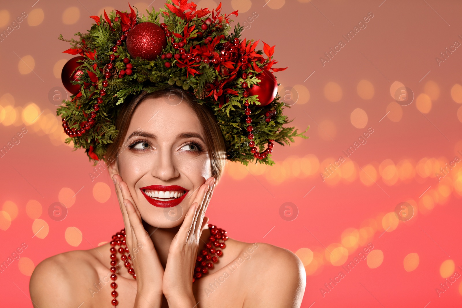 Photo of Beautiful young woman wearing Christmas wreath against blurred festive lights. Space for text