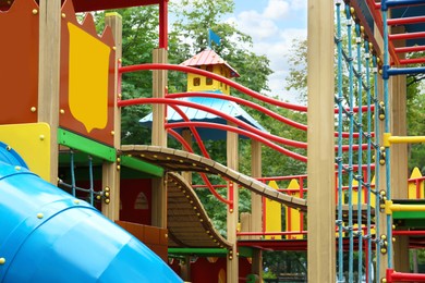 Photo of New colorful castle playhouse with climbing frame on children's playground