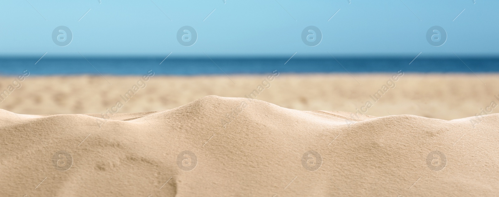 Image of Beautiful beach with golden sand near sea, closeup view. Banner design