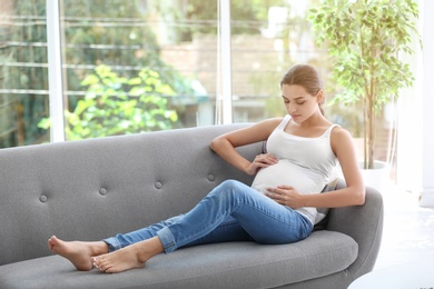 Photo of Young pregnant woman at home. Gynecology