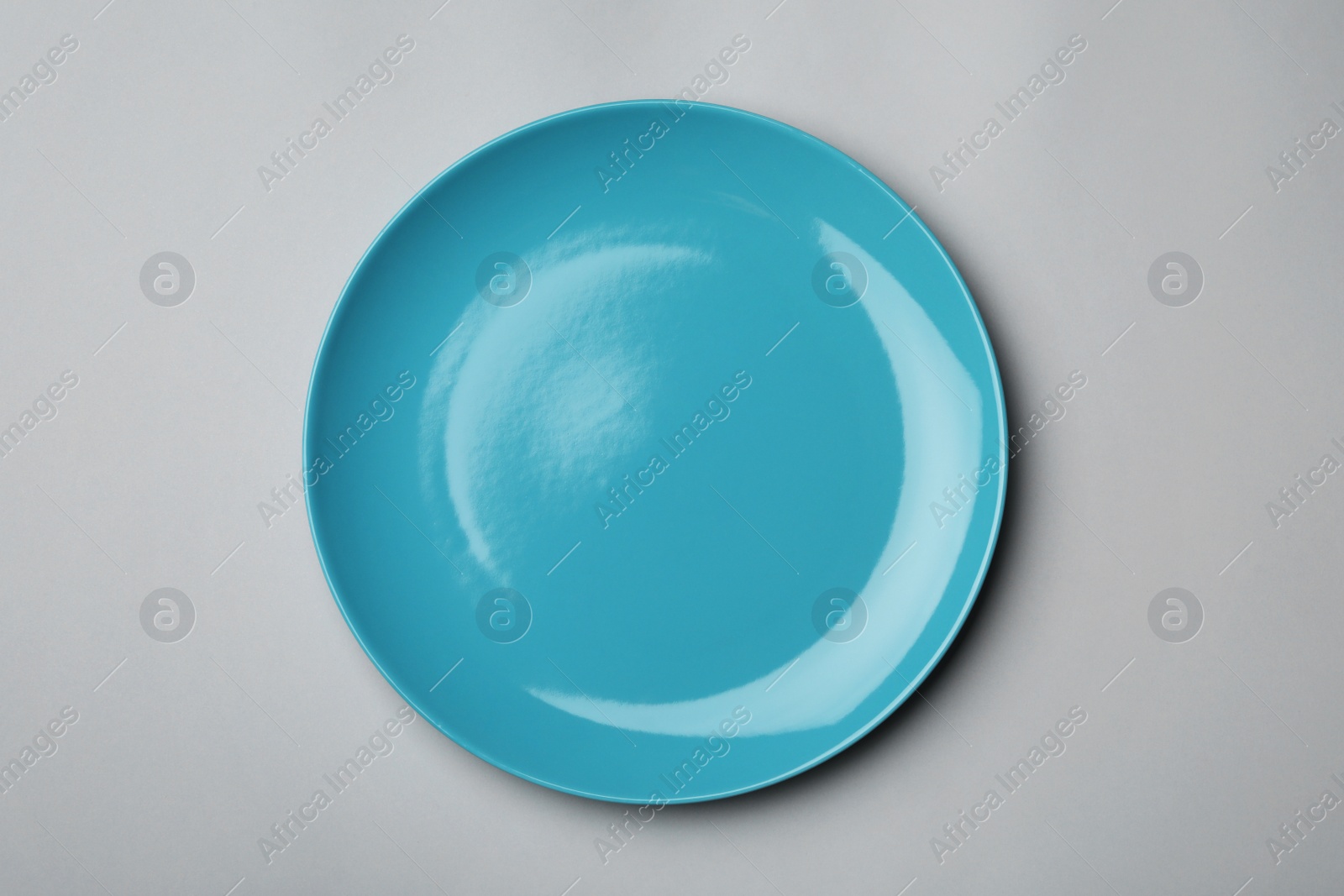 Photo of Clean empty plate on grey background, top view