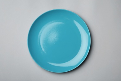 Clean empty plate on grey background, top view