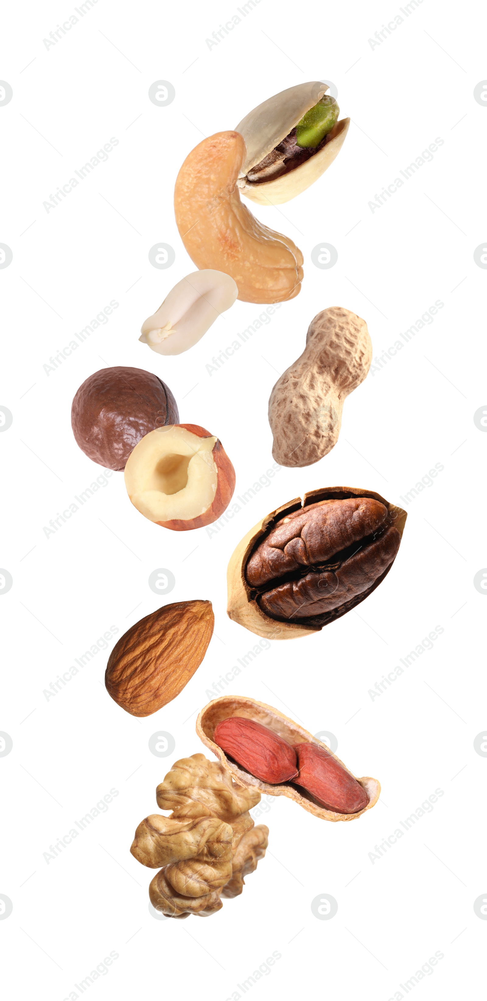 Image of Many different nuts in air on white background