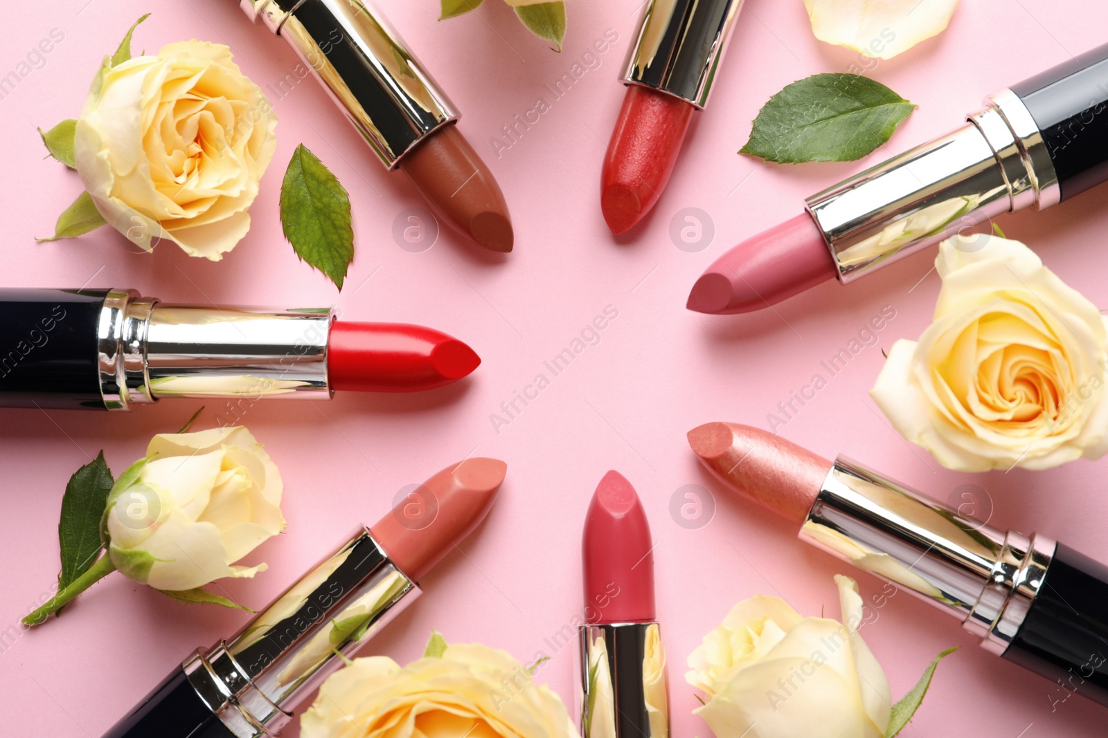 Photo of Flat lay composition with lipsticks and roses on color background