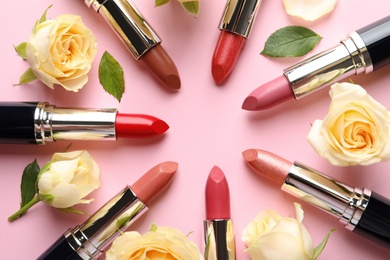 Photo of Flat lay composition with lipsticks and roses on color background