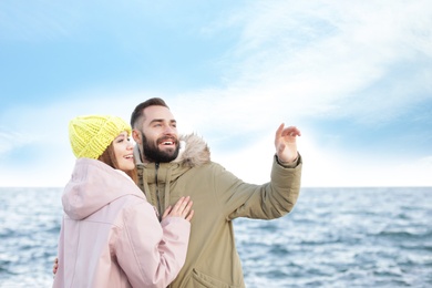 Lovely young couple spending time near sea