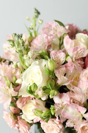 Photo of Beautiful bouquet of fresh flowers on light background, closeup