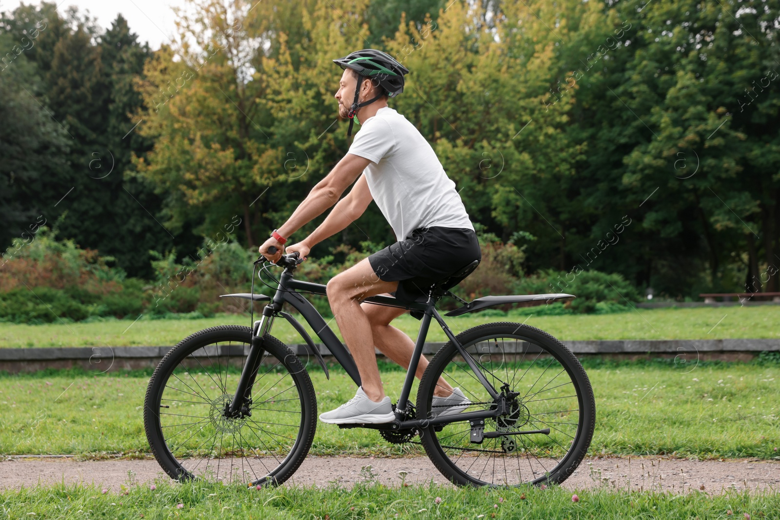 Photo of Man riding bicycle on road at park