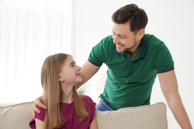 Father talking with his teenager daughter at home